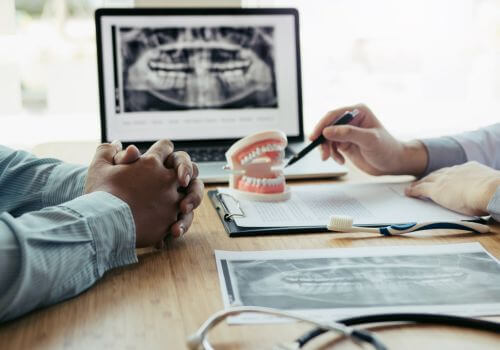 Dentist and patient discussing sinus lift procedure..
