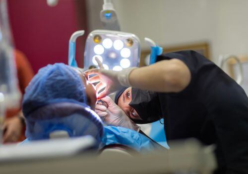 Dental Surgeon working on client for full mouth rehabilitation.